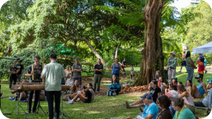 People gather in a botanical garden to listen to music