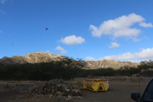 Shows helicopter sling load of Diamond Head Summit Demolition Materials