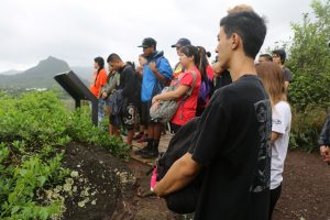 Group of visitors reading educational signage at Kawainui-Hāmākua marsh