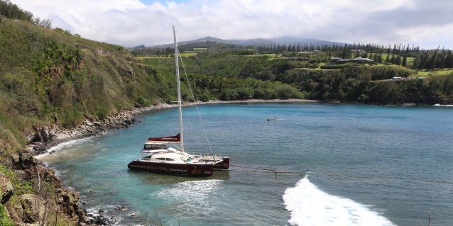 Photo from the cliff top of Maui’s Honolua-Mokulē‘ia Bay taken Mar-14-2025 shows vessel Hula Girl with ropes attached being towed from shore.