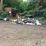 Photo of trash and debris dumped in front of public hunting area