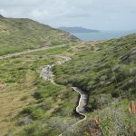 View from Makapuʻu Point Lighthouse Trail looking down at the trail to the parking area and the waters of Waimanalo, Oʻahu.