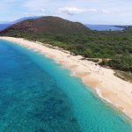 Aerial photo of Mākena State Park's long sandy beach on a sunny day, Maui, Hawaiʻi.