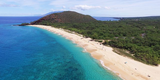 Aerial photo of Mākena State Park's long sandy beach on a sunny day, Maui, Hawaiʻi.